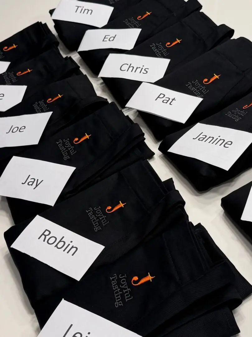 Name tags on black "Joyful Thinking" shirts.