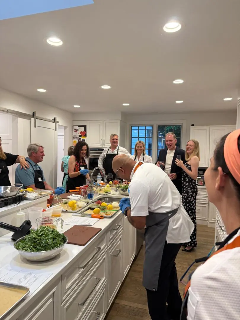 Group enjoying cooking class in kitchen.