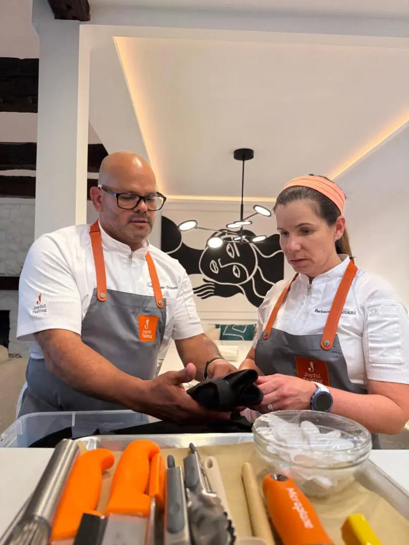 Chefs preparing in a modern kitchen setting.
