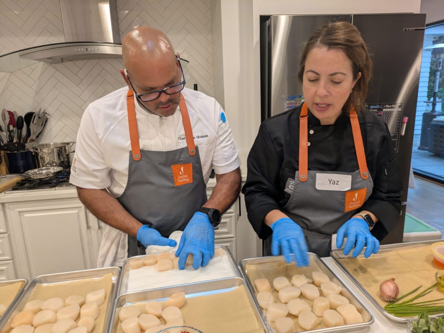 Chefs preparing food in a kitchen.