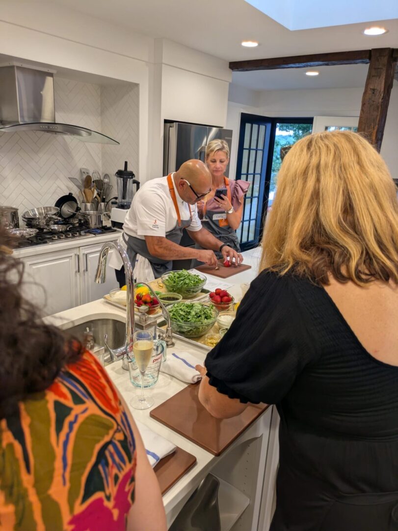 People cooking together in a modern kitchen.