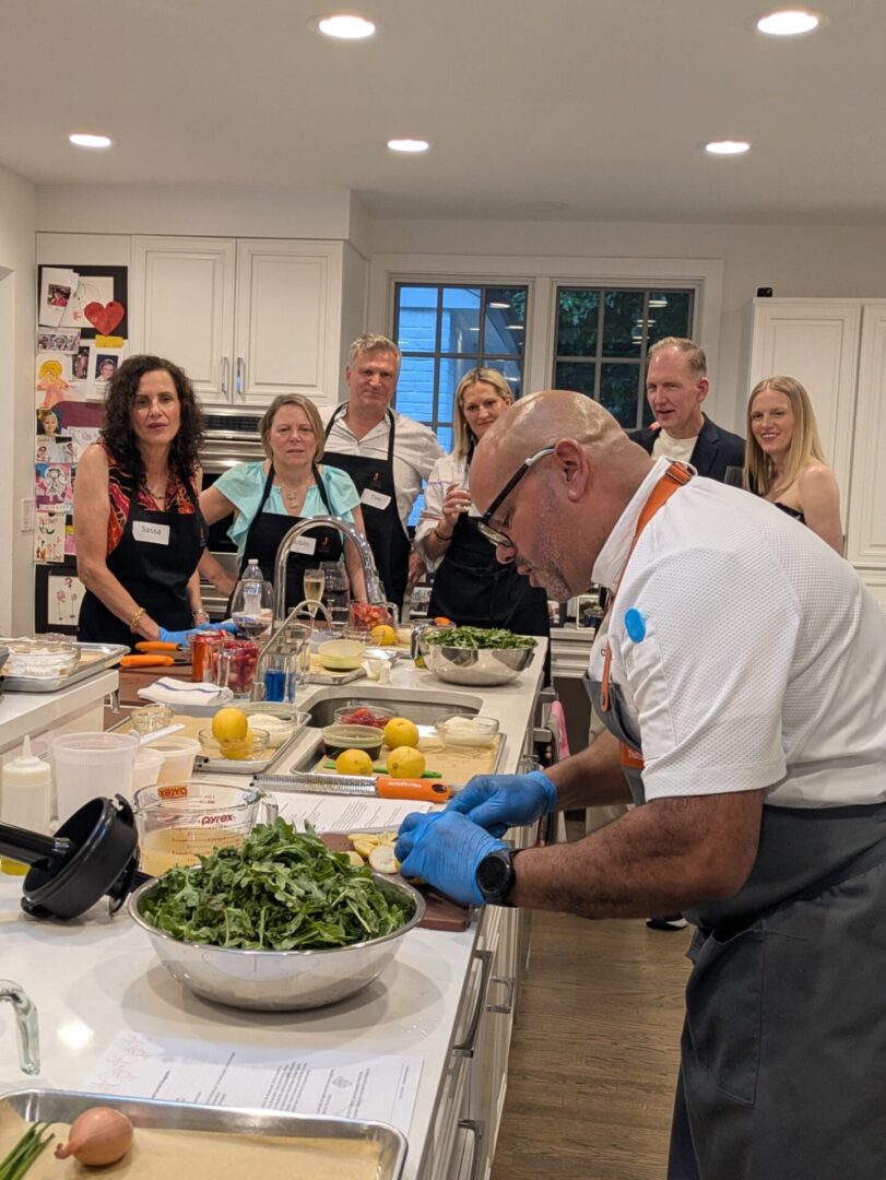 Chef preparing food for group cooking class.