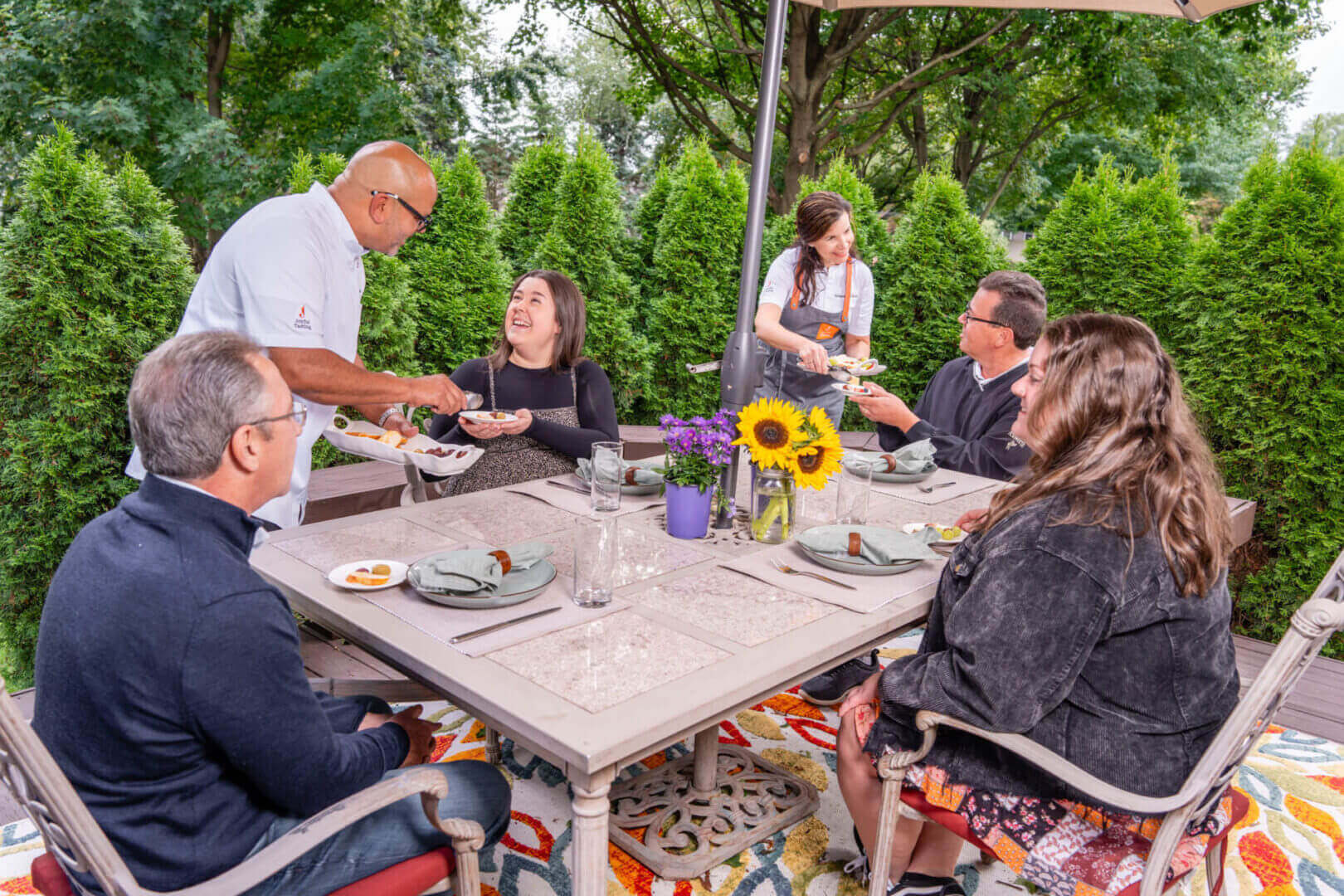 Outdoor dining with friends under a canopy.