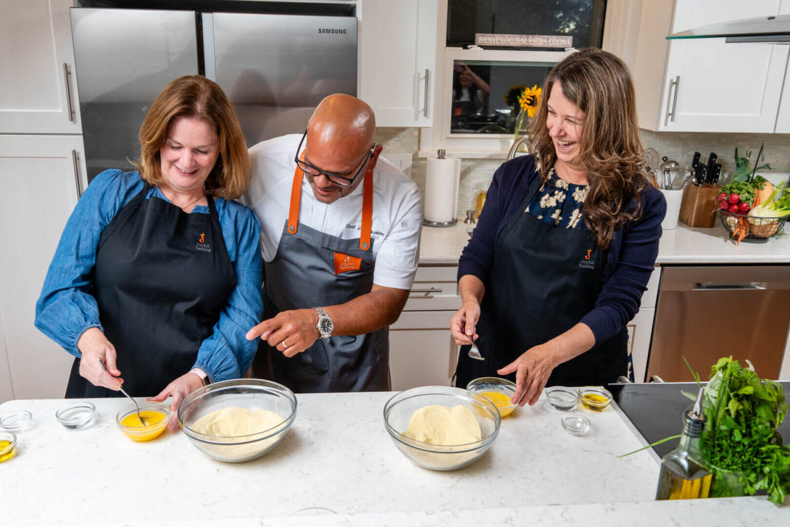People cooking together in a kitchen.