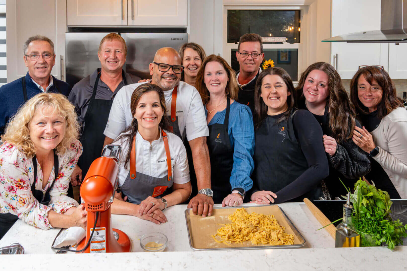 Group of people in a kitchen smiling.